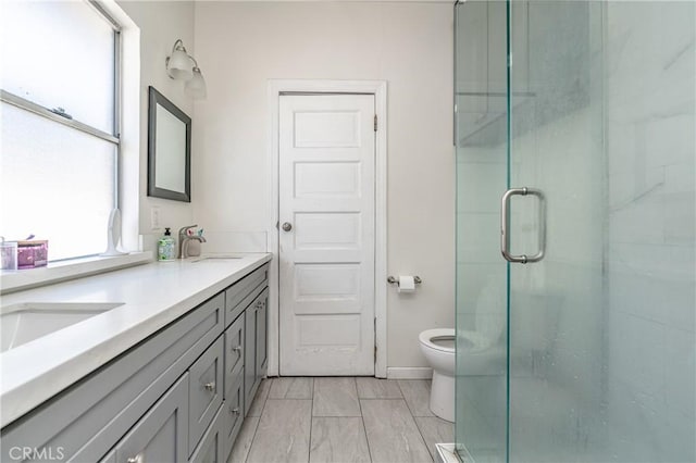 bathroom with vanity, a shower with shower door, and toilet