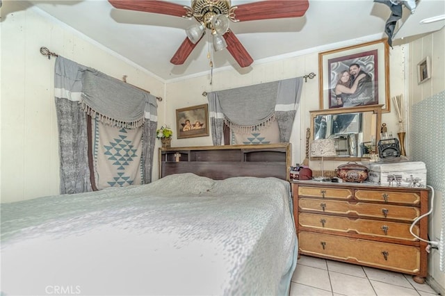 tiled bedroom featuring ceiling fan and crown molding