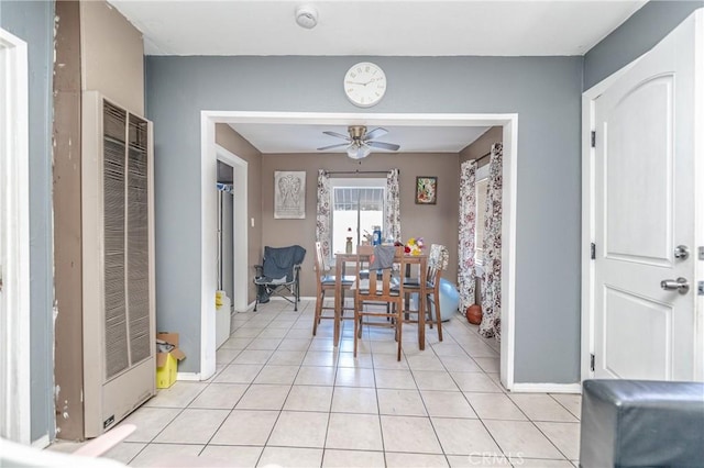 tiled dining area with ceiling fan