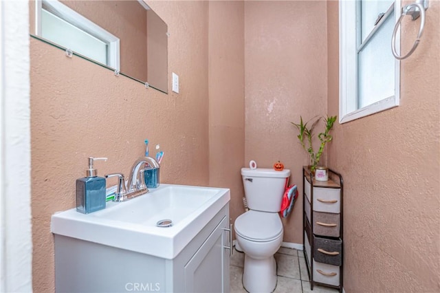 bathroom featuring tile patterned floors, vanity, and toilet