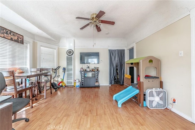 interior space featuring hardwood / wood-style floors, a textured ceiling, and ceiling fan