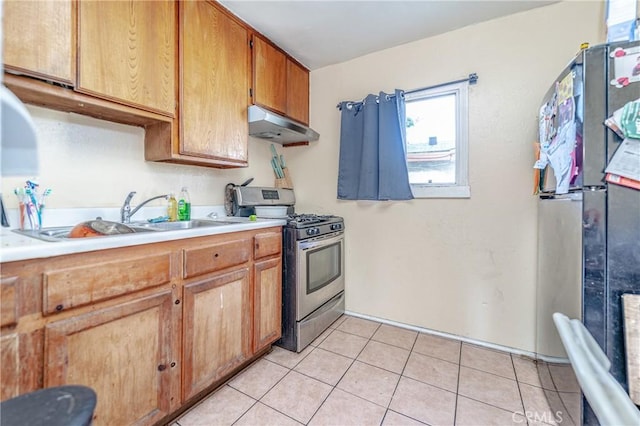 kitchen featuring light tile patterned flooring, sink, and appliances with stainless steel finishes