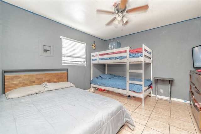 tiled bedroom featuring ceiling fan