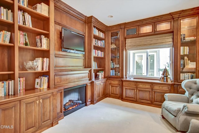 living area with built in features and light colored carpet