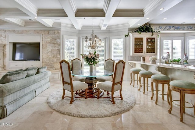 dining area featuring a notable chandelier, a healthy amount of sunlight, ornamental molding, and coffered ceiling