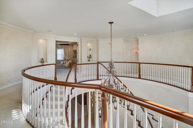 stairs featuring crown molding and a notable chandelier