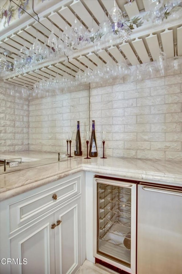 kitchen with white cabinetry and beverage cooler