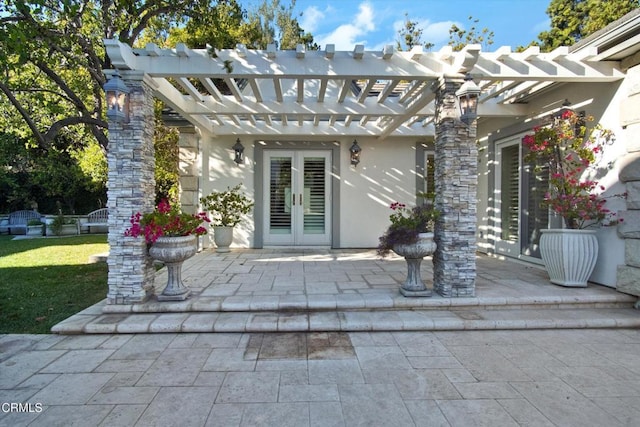 property entrance with a pergola and french doors