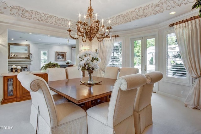 carpeted dining space featuring crown molding, french doors, and a notable chandelier