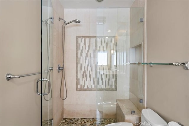 bathroom with an enclosed shower and toilet