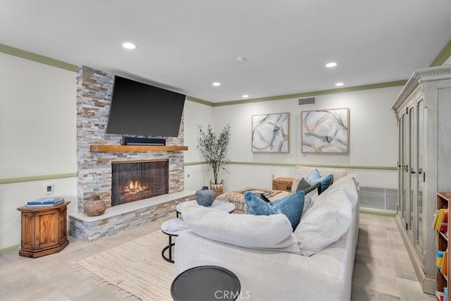 living room featuring a stone fireplace and ornamental molding