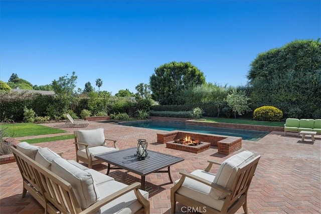 view of patio / terrace featuring an outdoor living space with a fire pit