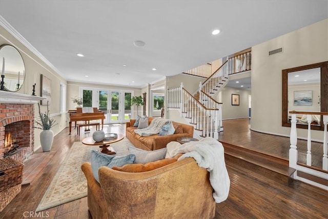 living room with a fireplace, french doors, dark hardwood / wood-style flooring, and ornamental molding