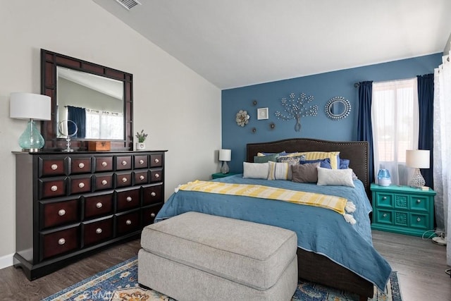 bedroom with vaulted ceiling and dark hardwood / wood-style floors