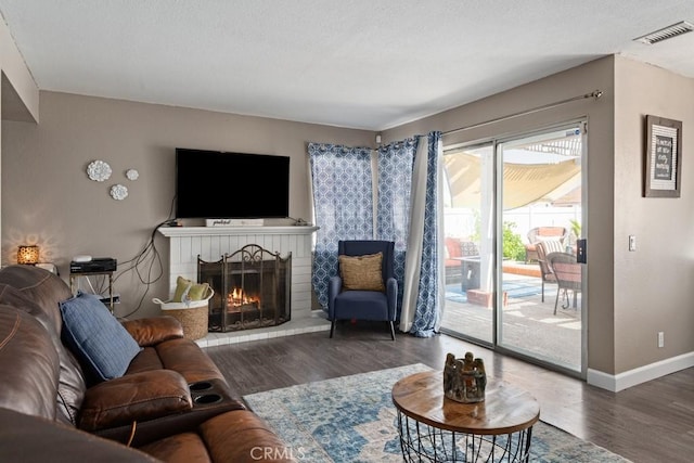 living room featuring dark hardwood / wood-style floors and a fireplace