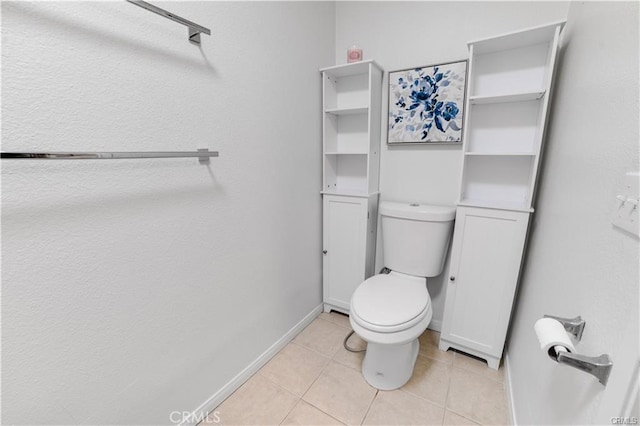 bathroom featuring toilet and tile patterned floors