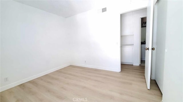 spare room featuring light wood-type flooring