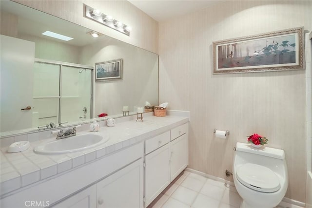 bathroom featuring tile patterned flooring, vanity, and toilet