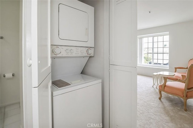 washroom with stacked washer and dryer and light colored carpet