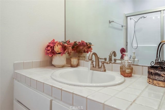 bathroom featuring vanity and a shower