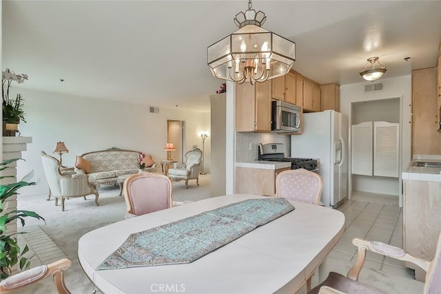 dining space featuring an inviting chandelier