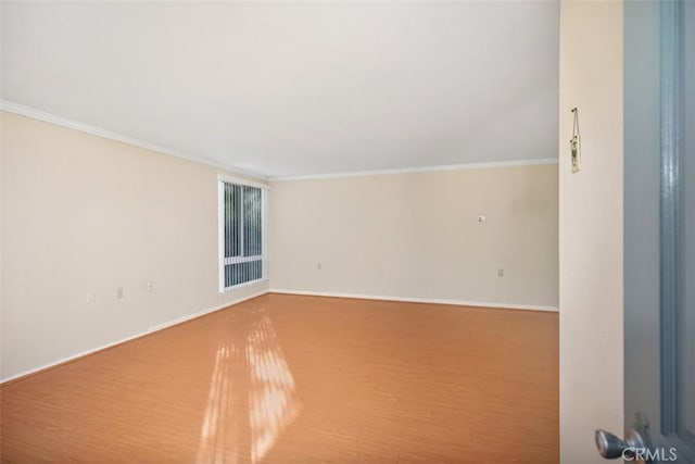 unfurnished room with hardwood / wood-style flooring and ornamental molding