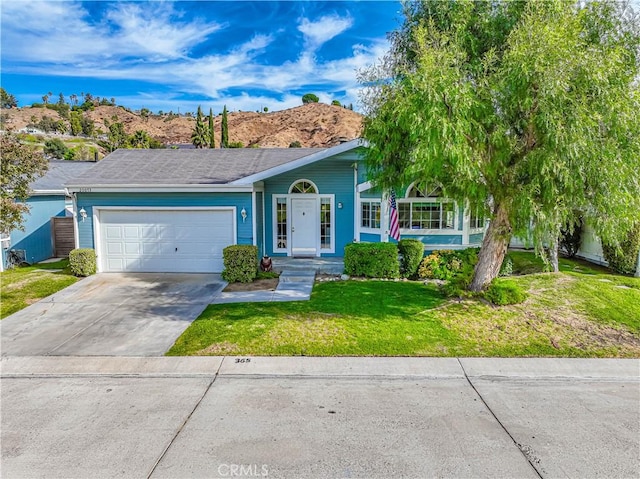 ranch-style house with a front yard, driveway, and an attached garage