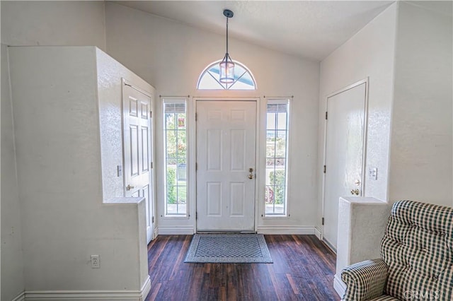 foyer with dark hardwood / wood-style flooring and vaulted ceiling