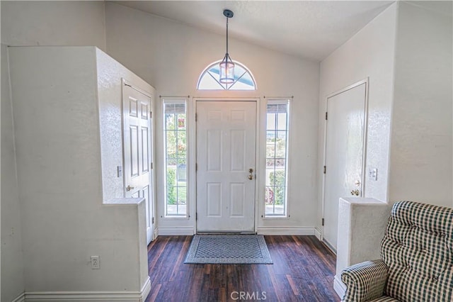 entryway featuring wood finished floors, lofted ceiling, and baseboards