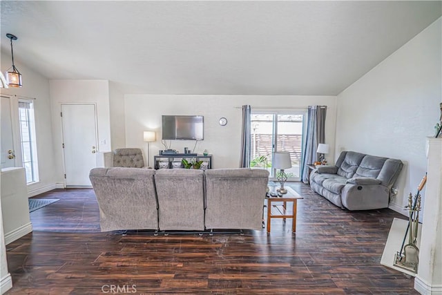 living area featuring baseboards, vaulted ceiling, and dark wood-type flooring