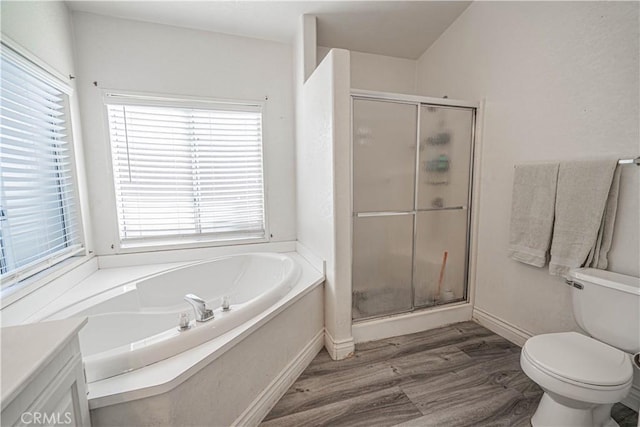 full bath featuring a shower stall, a garden tub, toilet, a wealth of natural light, and wood finished floors