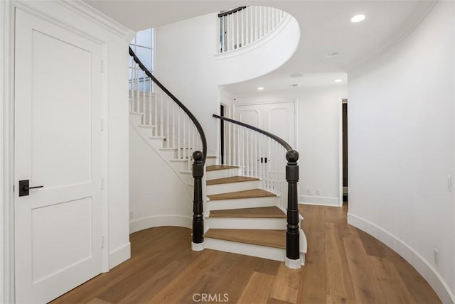 stairs with hardwood / wood-style floors