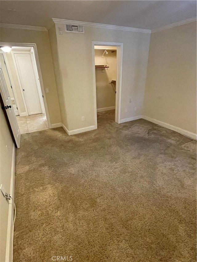 unfurnished room with ornamental molding and light colored carpet