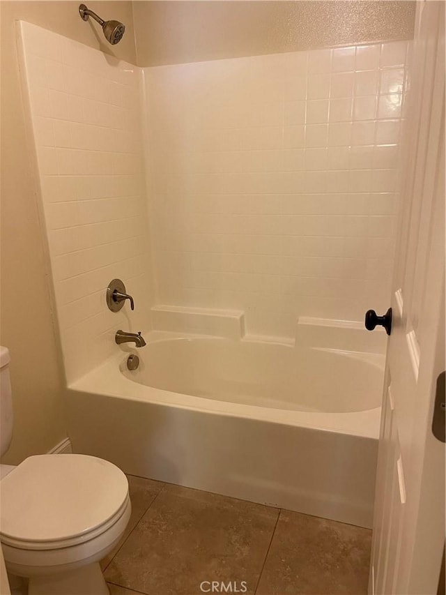 bathroom featuring tub / shower combination, tile patterned floors, and toilet