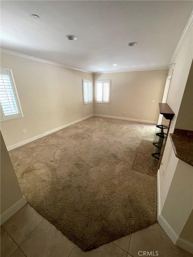 basement featuring tile patterned flooring and crown molding