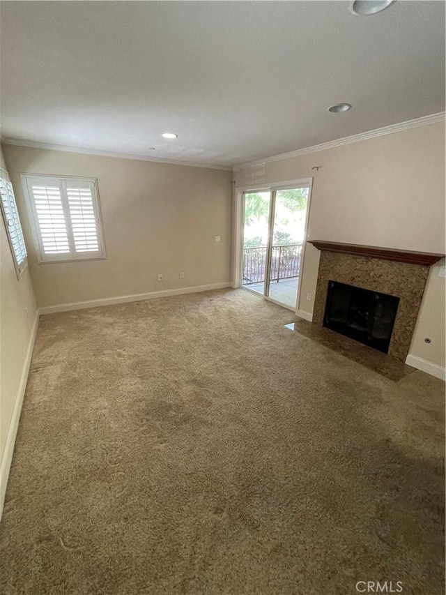 unfurnished living room featuring carpet and crown molding