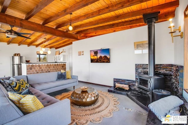 living room with wooden ceiling, a wood stove, and beam ceiling