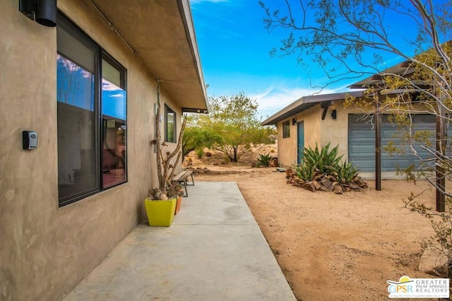 view of property exterior with a patio