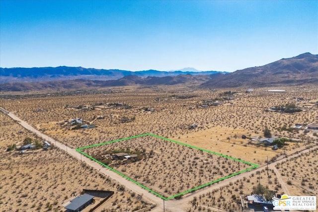 birds eye view of property featuring a mountain view