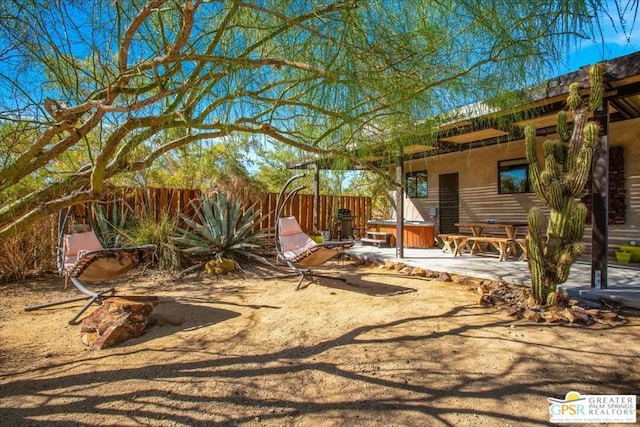 view of yard with a hot tub and a patio