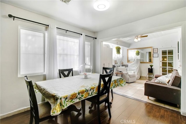 dining area with ceiling fan, hardwood / wood-style floors, and lofted ceiling