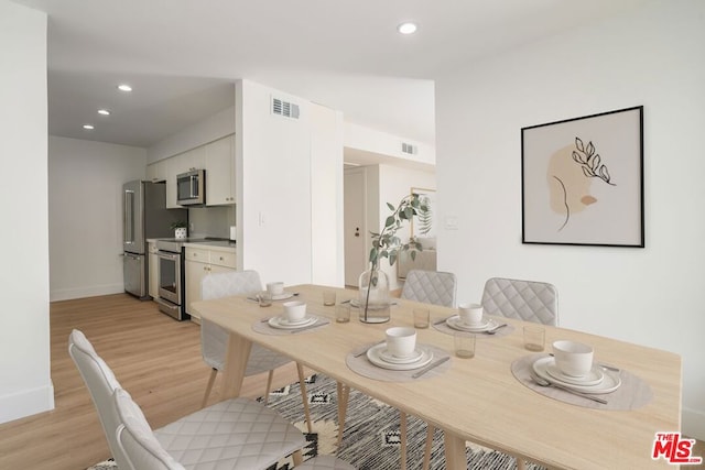 dining area with light hardwood / wood-style floors