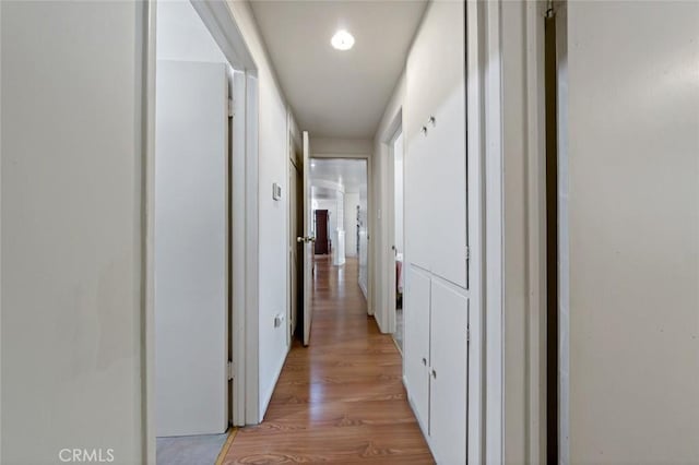 hall with light hardwood / wood-style floors