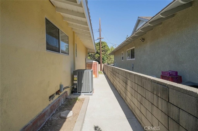 view of side of property featuring central AC