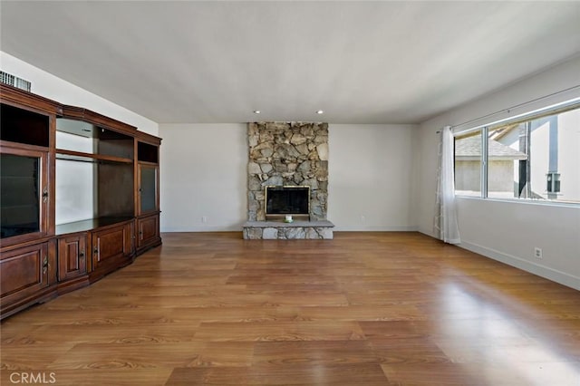 unfurnished living room with light hardwood / wood-style floors and a fireplace