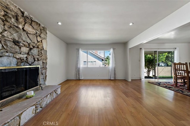 unfurnished living room with a fireplace and light wood-type flooring