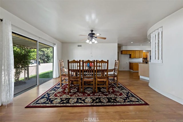 dining space with light hardwood / wood-style flooring and ceiling fan