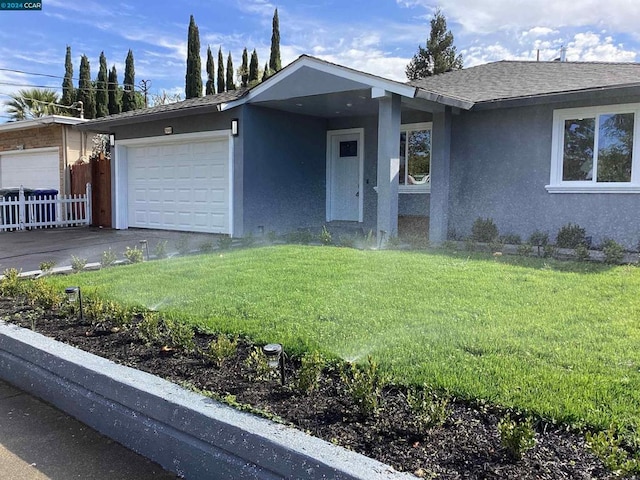 ranch-style home featuring a front yard and a garage