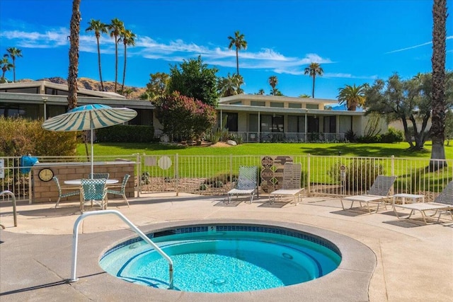 view of pool with a yard, a hot tub, and a patio area