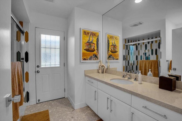 bathroom featuring vanity and walk in shower